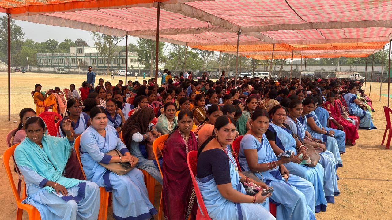 Large gathering of seated individuals outdoors.